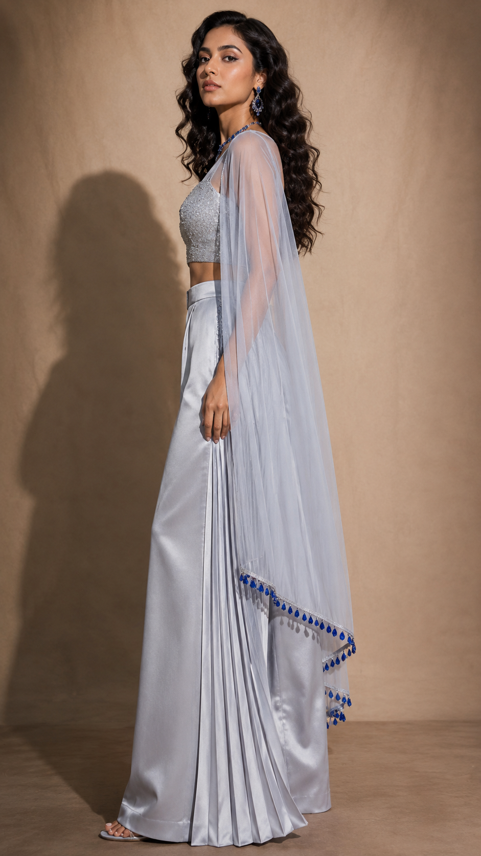 Silver sari-trouser look with sheer blue bead cape